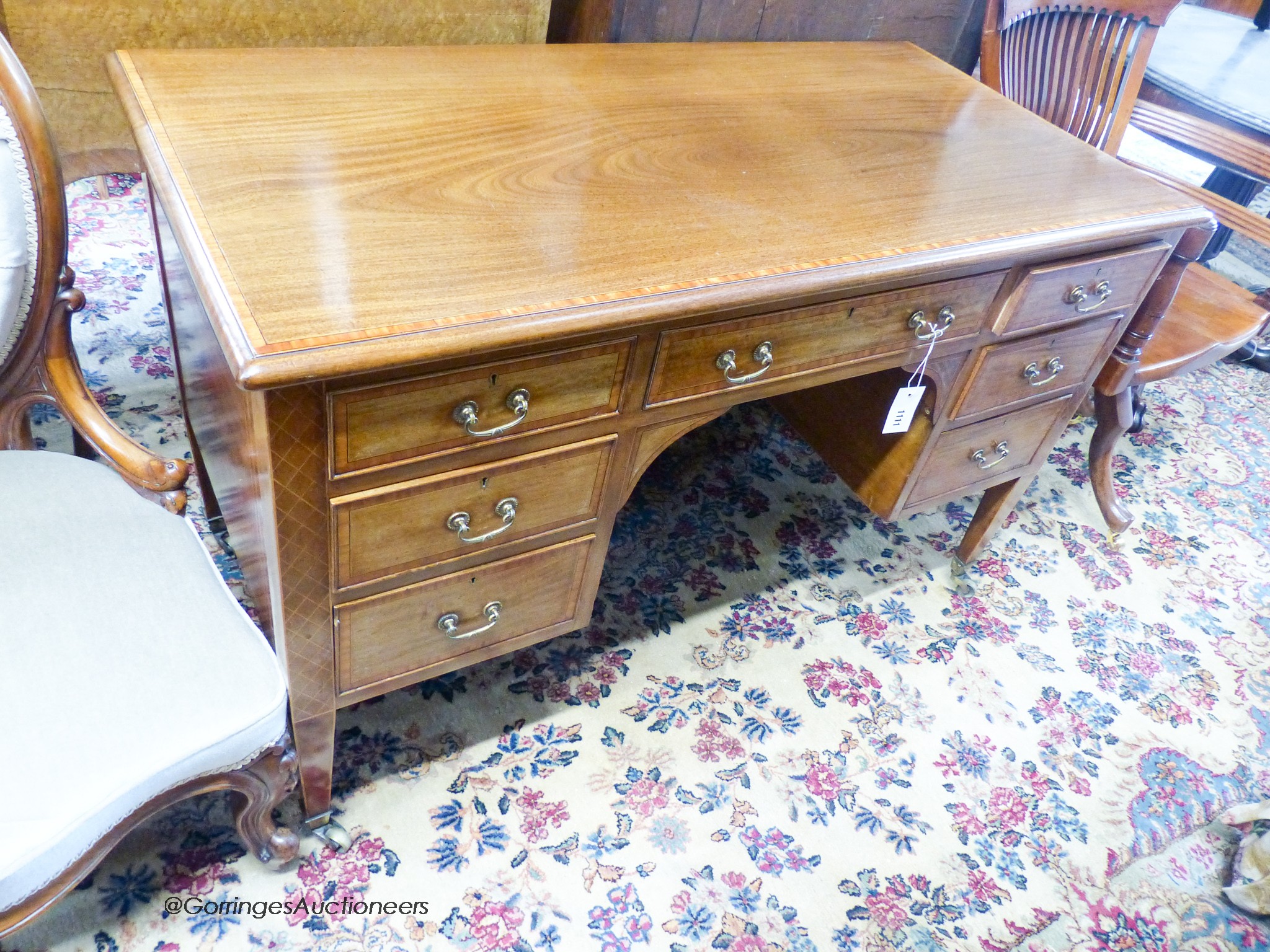 An Edwardian satinwood banded mahogany kneehole dressing table, width 122cm, depth 58cm, height 76cm